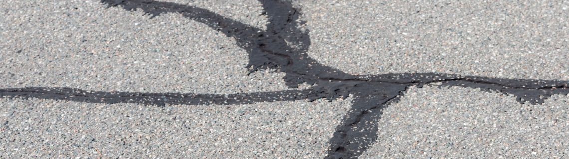Cracked asphalt repaired with C-23 maltene-based restorative asphalt seal