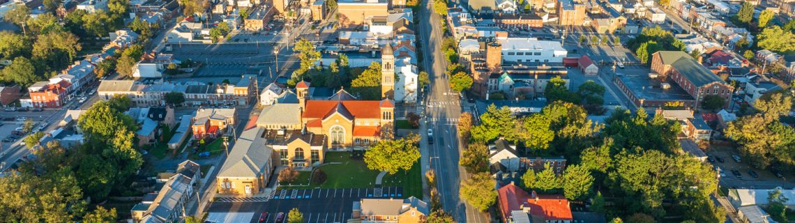 Aerial view of a small town with trees, homes, and businesses